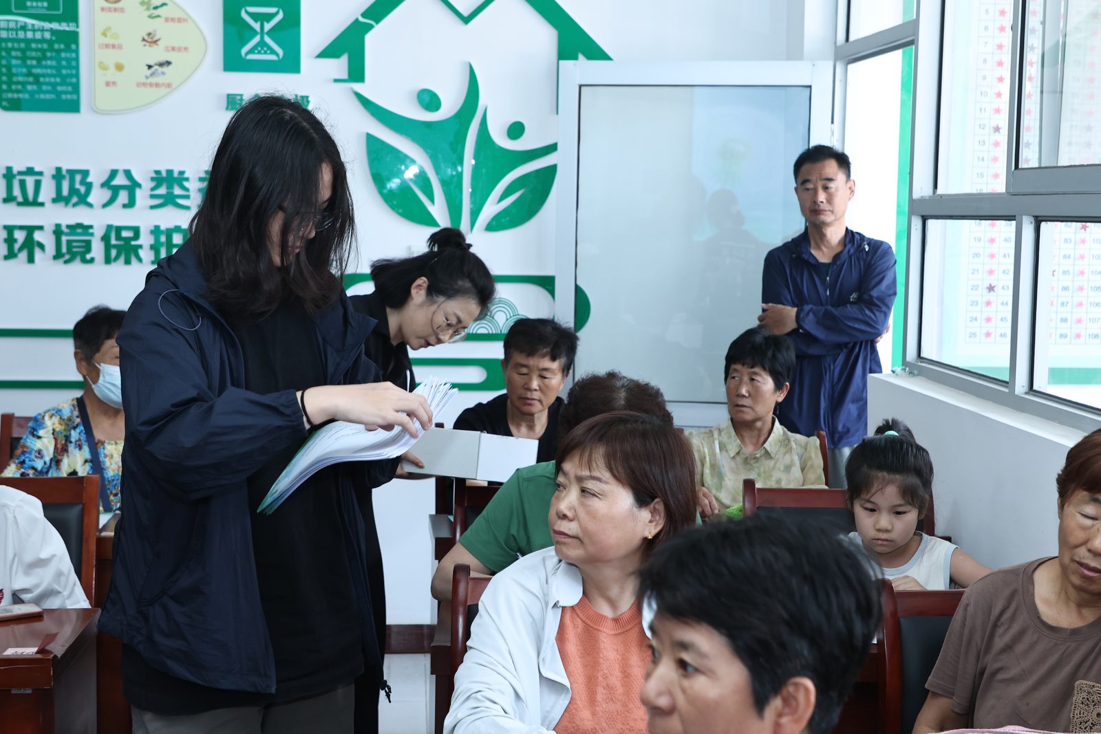 Volunteers distributing questionnaires during the Beijing session